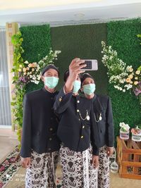 Full length of man standing by flower plants