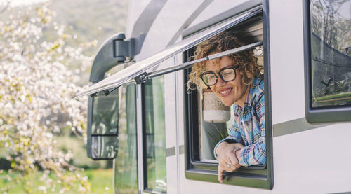 Low angle view of woman looking through window