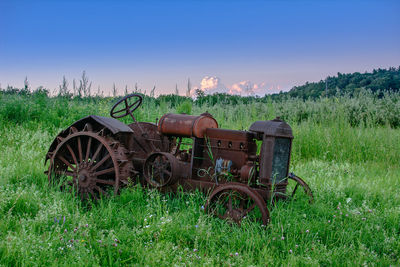 Tractor on field against sky