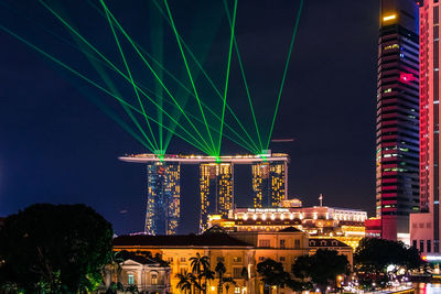 Illuminated modern buildings in city at night