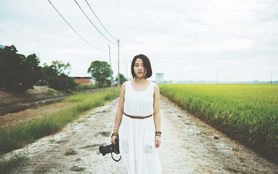 Full length of woman standing on grassy field