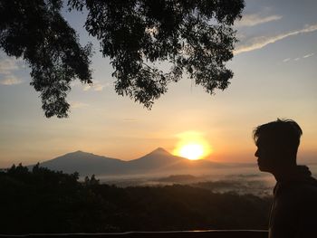 Silhouette man against sky during sunset