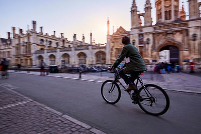 Man with bicycle in front of building