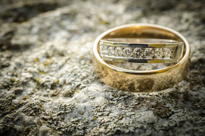 Wedding and engagement rings on rock