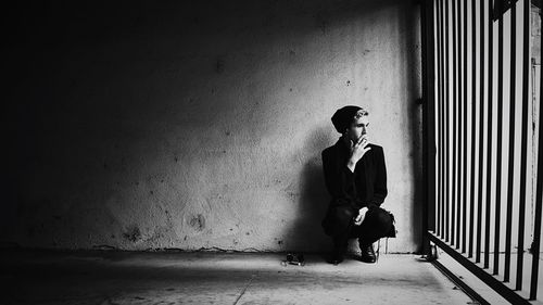 Man smoking cigarette in prison