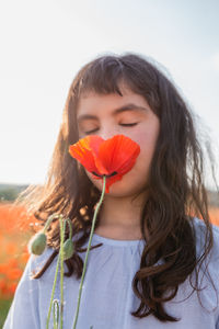 Portrait of young woman holding flower