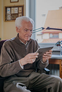 Midsection of man using mobile phone