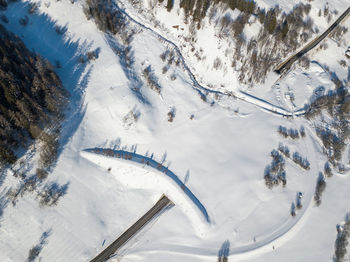 High angle view of people skiing on snow covered mountain