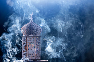 Smoke emitting from illuminated temple