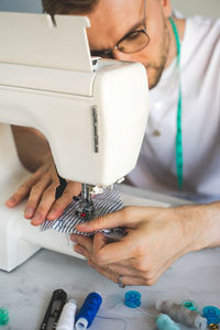 Cropped hands sewing machine