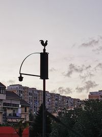 Street light against buildings in city