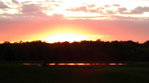 Scenic view of silhouette trees against sky during sunset