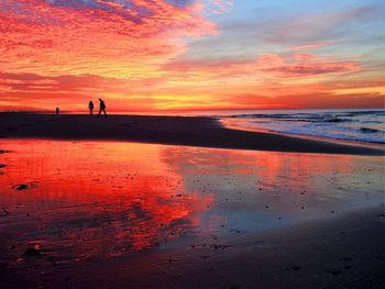 Scenic view of beach against sky during sunset