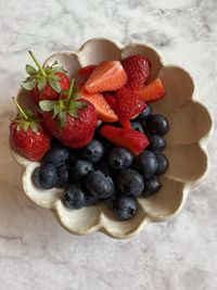 High angle view of strawberries in bowl on table