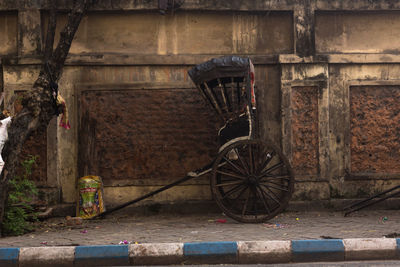 Abandoned bicycle against brick wall