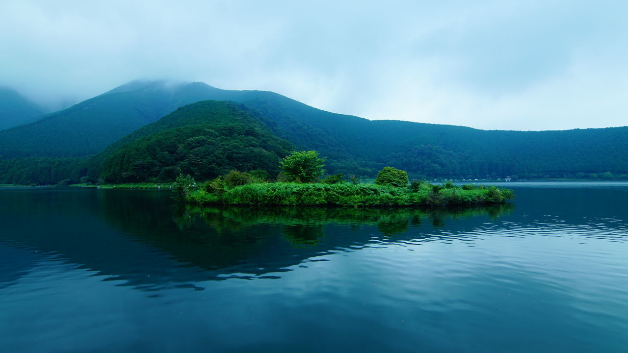 mountain, tranquil scene, water, tranquility, scenics, beauty in nature, lake, waterfront, nature, sky, non-urban scene, sea, calm, green color, growth, majestic, cloud - sky, mountain range, outdoors, no people, remote, green