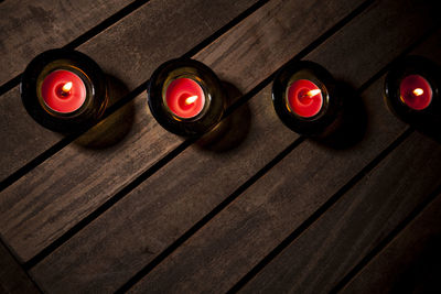 High angle view of illuminated candles on table