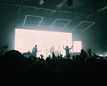 Group of silhouette people at music concert