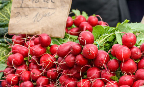 Close-up image of radishes for sale on market stall. farmer's market, vegetables, healthy.