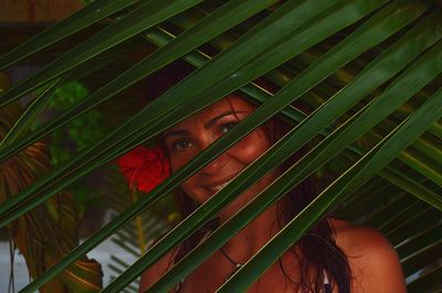 Close-up portrait of woman with plants