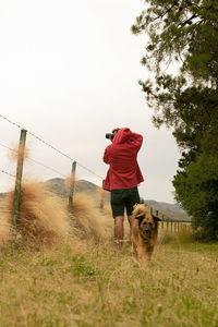 Dog on field against sky