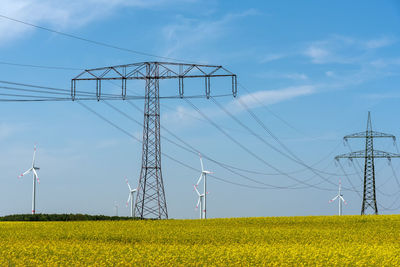 Power supply lines and some wind engines seen in rural germany