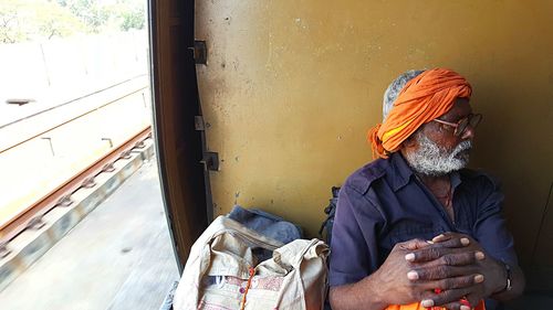 High angle view of man with luggage traveling in train