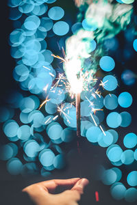 Close-up of hand holding illuminated lights