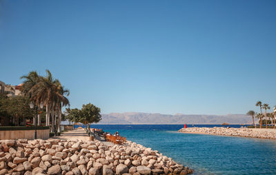 Scenic view of sea against clear blue sky