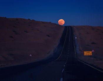 View of road against clear sky at night