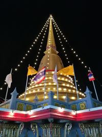 Low angle view of illuminated temple against sky at night