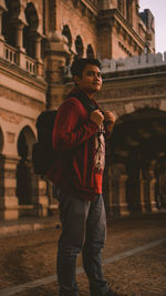 Full length portrait of young man standing in city