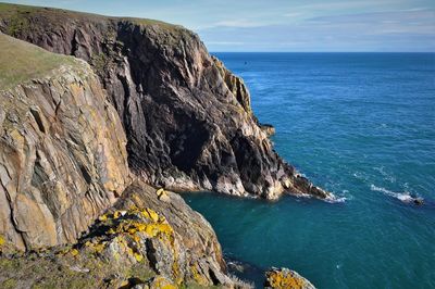 Rock formations by sea against sky