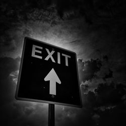 Low angle view of road sign against sky