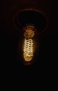 Close-up of illuminated light bulb