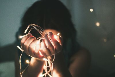 Woman holding illuminated lighting equipment