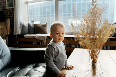 Cute boy sitting at home