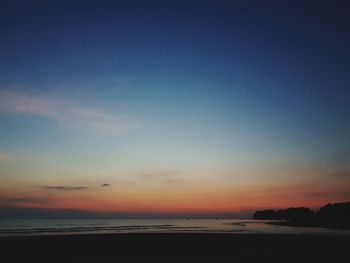 Scenic view of beach against sky during sunset