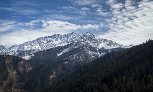 Scenic view of snowcapped himalayas against cloudy sky