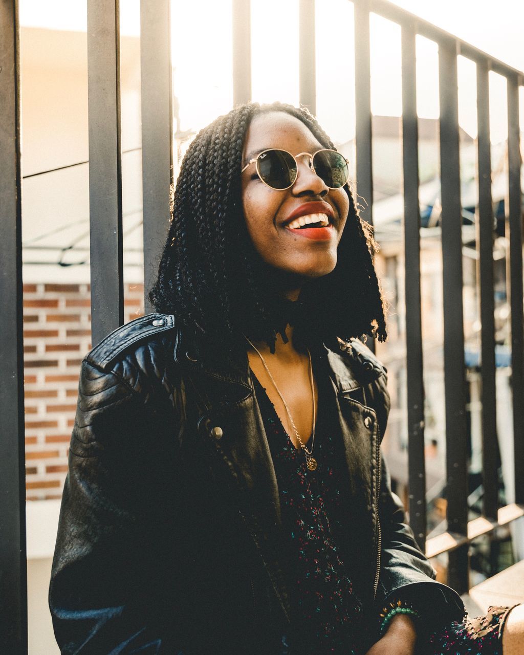 one person, glasses, clothing, leisure activity, fashion, young adult, front view, lifestyles, sunglasses, real people, portrait, jacket, smiling, hairstyle, waist up, young women, standing, long hair, looking at camera, hair, beautiful woman, outdoors, scarf, warm clothing