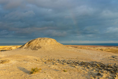 Mud volcanoes of gobustan near baku, azerbaijan. mud mountain and stormy sky