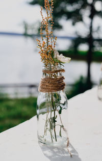 Hand made decor for serving with white flowers in a glass bottle