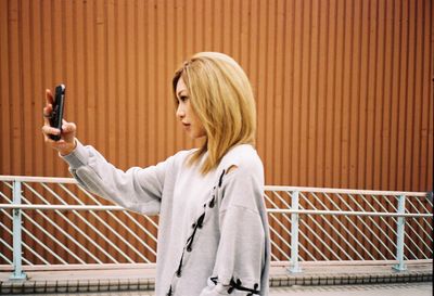 Woman standing on railing