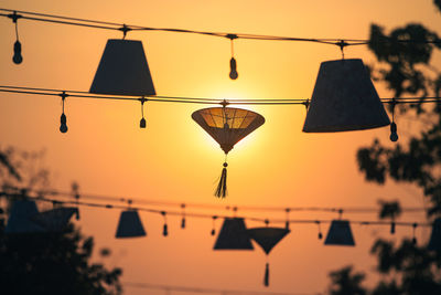 Silhouettes of traditional lanterns hanging above street in hoi an in vietnam.