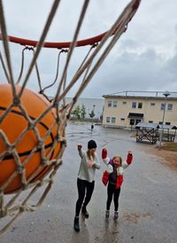 Mother and daughter making basket throw