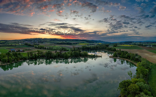 Scenic view of lake against sky during sunset