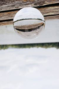 Close-up of crystal ball on wooden surface