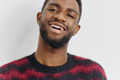 Portrait of young man against white background