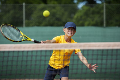 Boy playing tennis