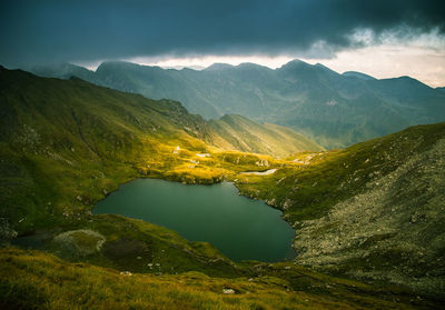 Scenic view of lake and mountains against sky